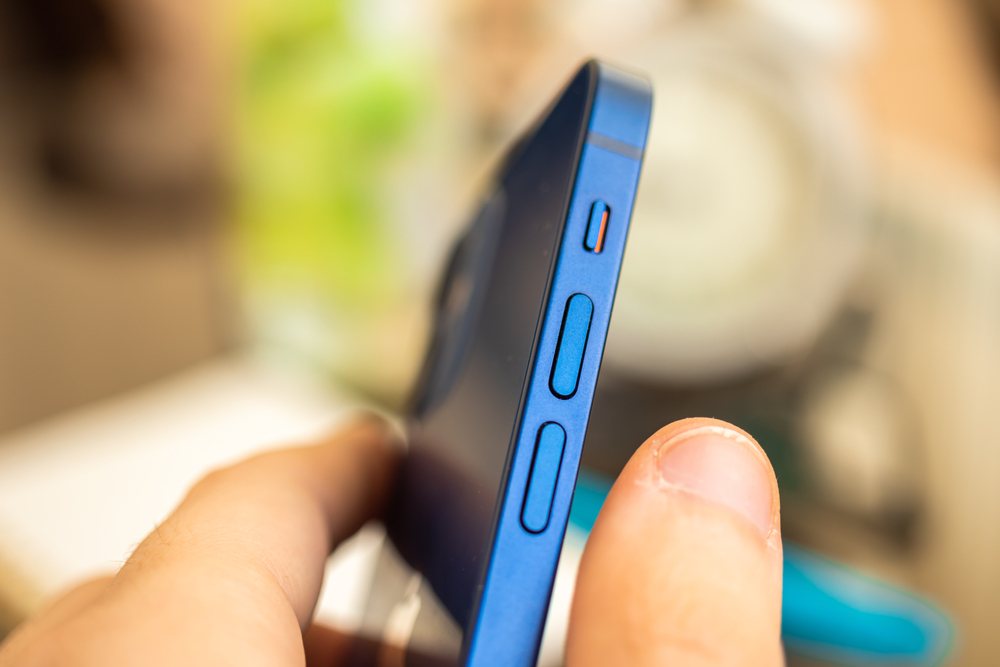 Kharkov, Ukraine - April 27, 2021: Apple iPhone 12 volume buttons close up, side silence slider