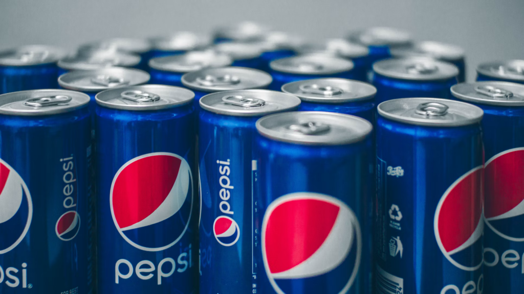 Multiple Pepsi cans arranged together, emphasizing the high sugar content that can cause blood sugar spikes, increasing the risk of diabetes and other health issues for individuals over 60.