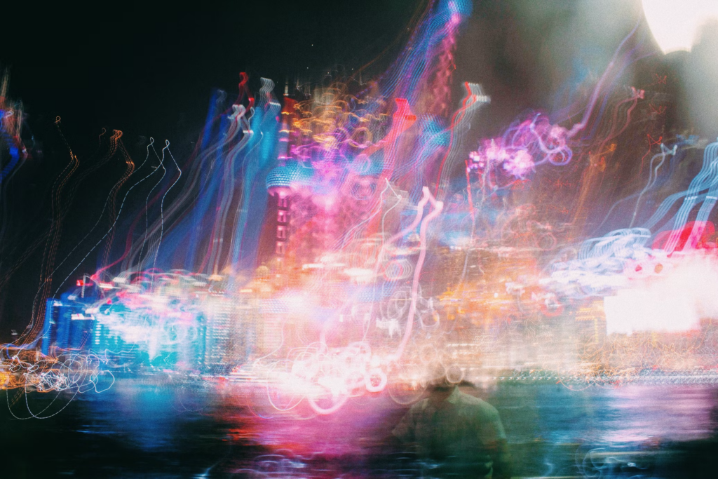 A hazy view of a city at night, where twinkling lights blend together in a beautiful, distorted vision.