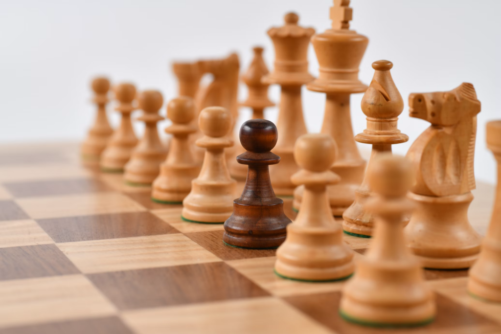 A close-up of chess pieces arranged on a board, symbolizing the struggle with change and memory loss in dementia.