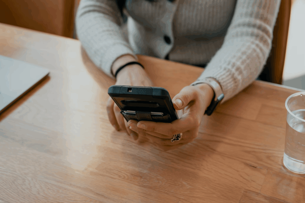 Person using smartphone to maintain social connections that support heart health and reduce isolation.