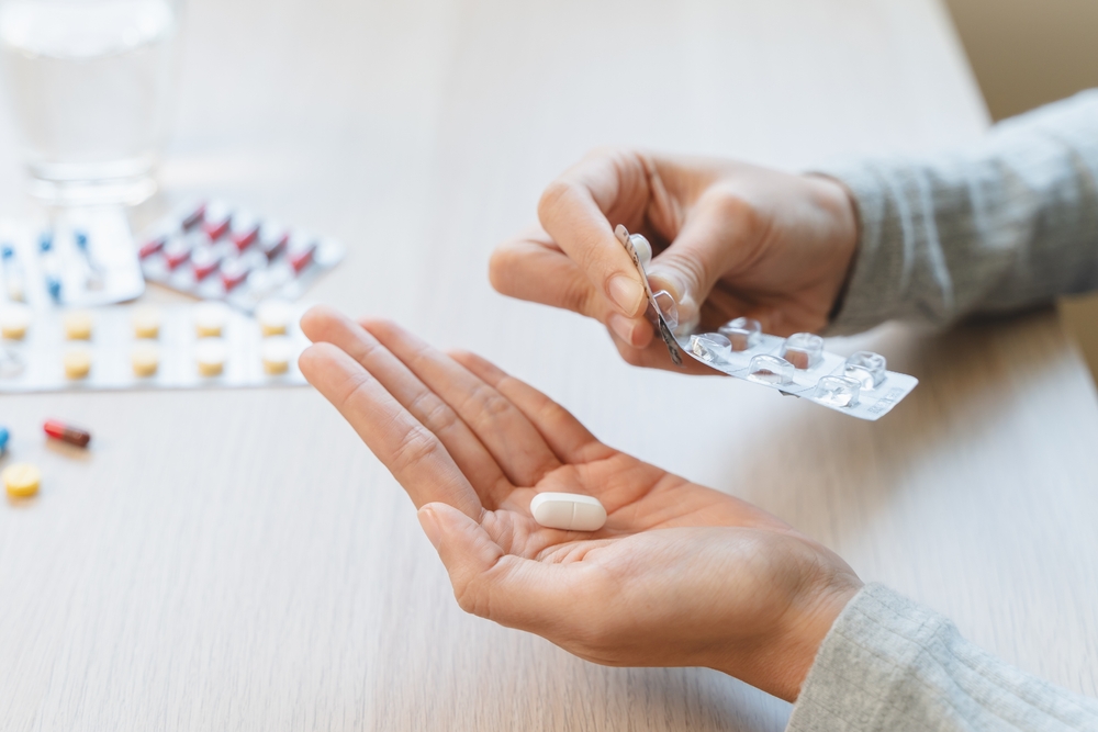 Healthcare Harmony: Close-Up Hands Holding Medication and Water Glass for Optimal Wellness, Pharmaceutical Treatment and mental health treatment